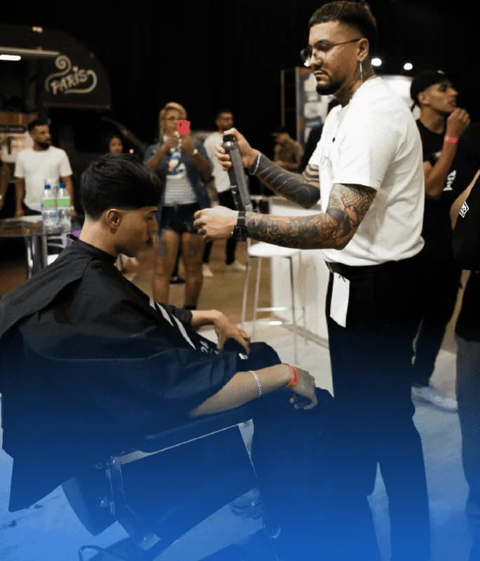 Barber working at an event and sharing the impact of WeiBook