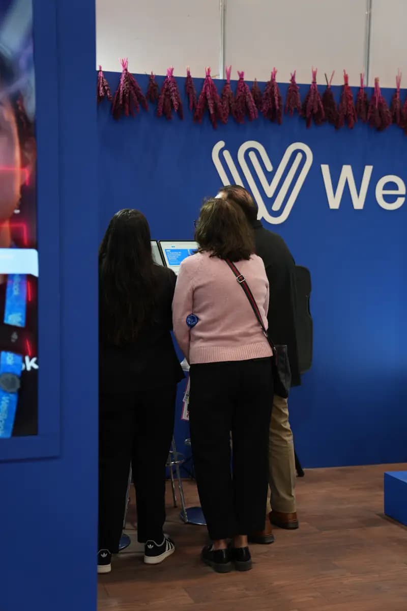 Visitors watch a WeiBook demo at a stand in Mexico