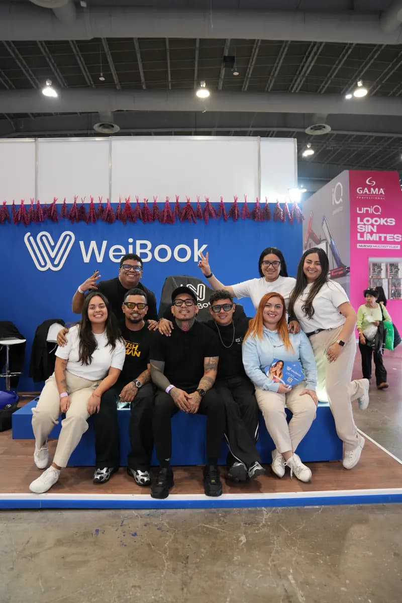 Team members and clients pose at the WeiBook stand in Mexico